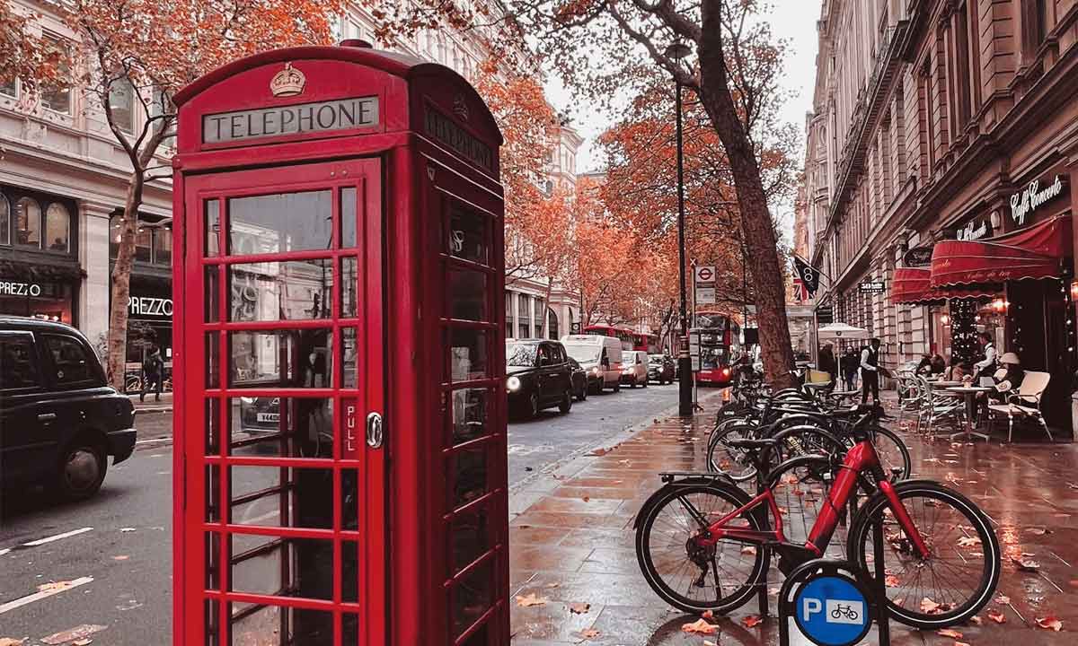 London iconic red phone box and bicycles in Autumn